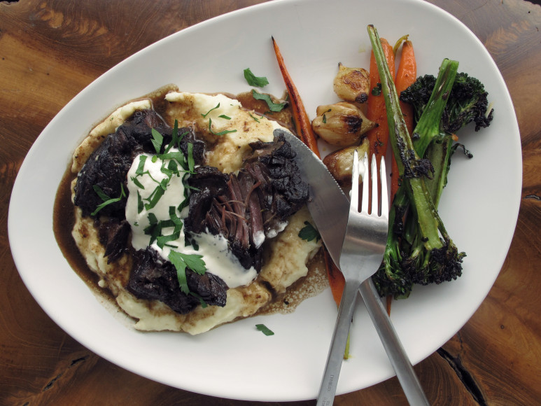 plated briased short rib with parsnip puree and roasted vegetables